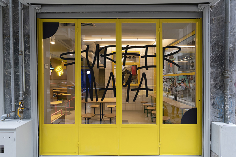 graffiti fonts and neon signs characterize studiomateriality's 'surfer maya' restaurant in greece