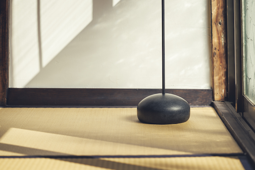 spindle coat rack by koichi futatsumata gently sways when garments are hung on it