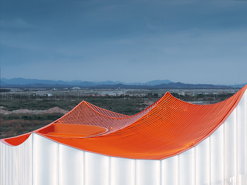 wutopia lab's luminous showroom with sweeping orange peaks echoes chinese mountainscape