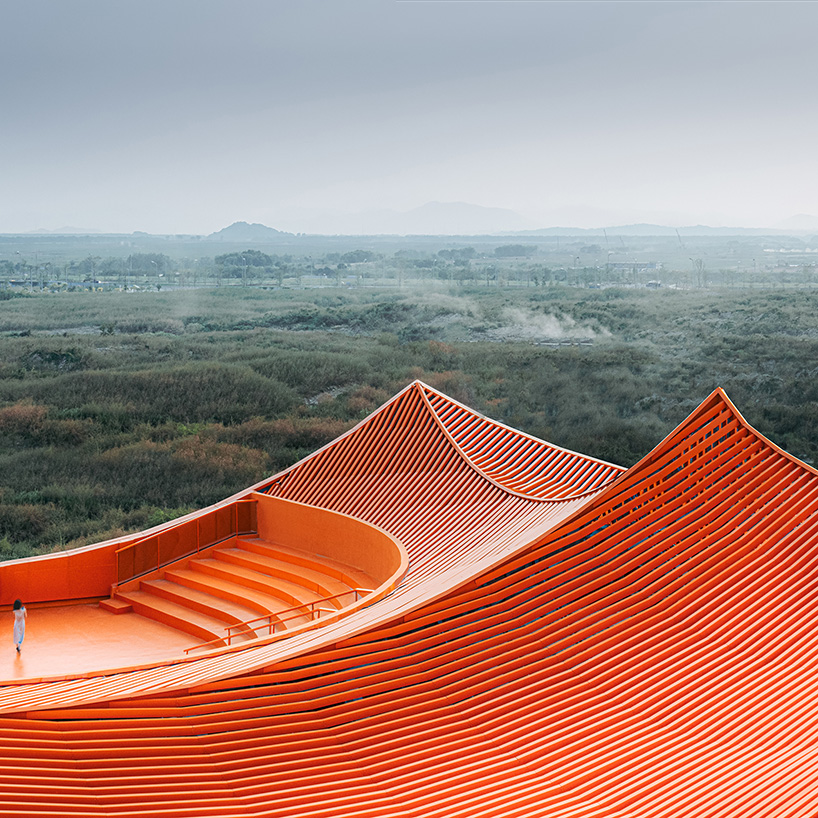 wutopia lab's luminous showroom with sweeping orange peaks echoes chinese mountainscape