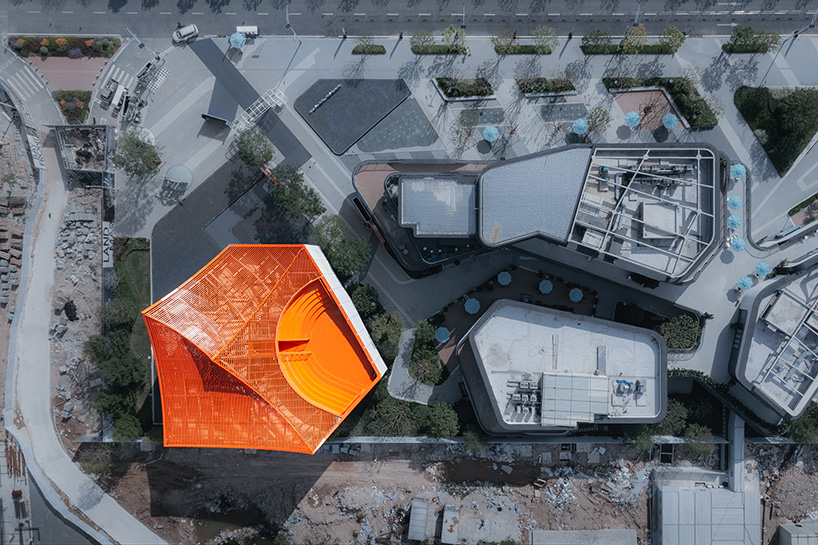 wutopia lab's luminous showroom with sweeping orange peaks echoes chinese mountainscape