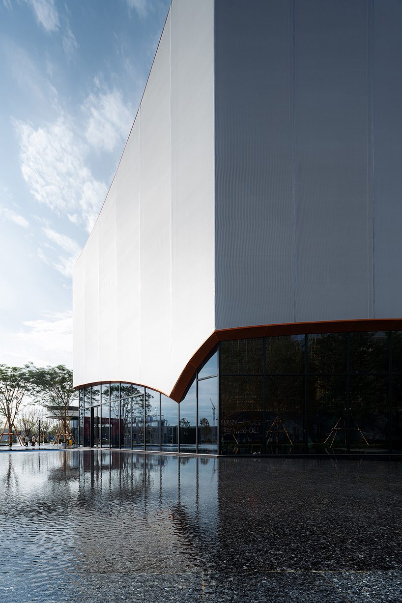 wutopia lab's luminous showroom with sweeping orange peaks echoes chinese mountainscape