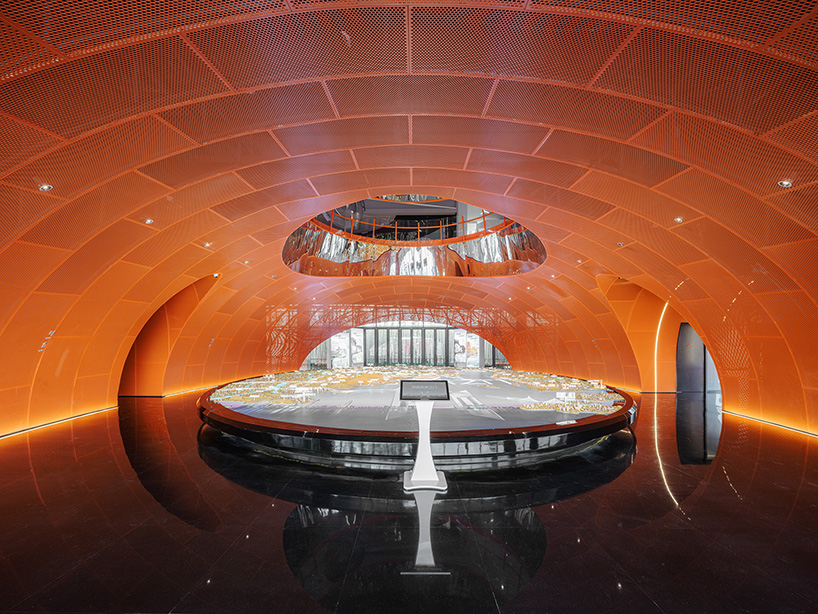 wutopia lab's luminous showroom with sweeping orange peaks echoes chinese mountainscape