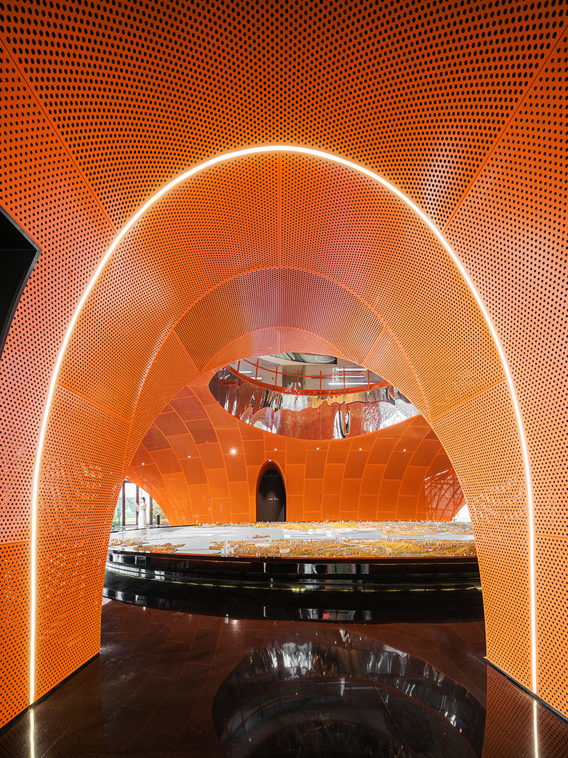 wutopia lab's luminous showroom with sweeping orange peaks echoes chinese mountainscape