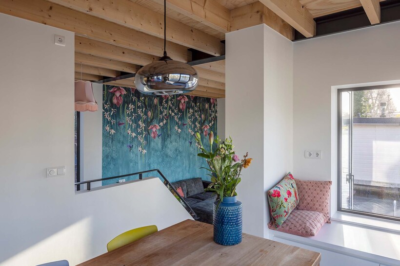 floating wooden houseboat by EVA architecten embraces canal views in utrecht