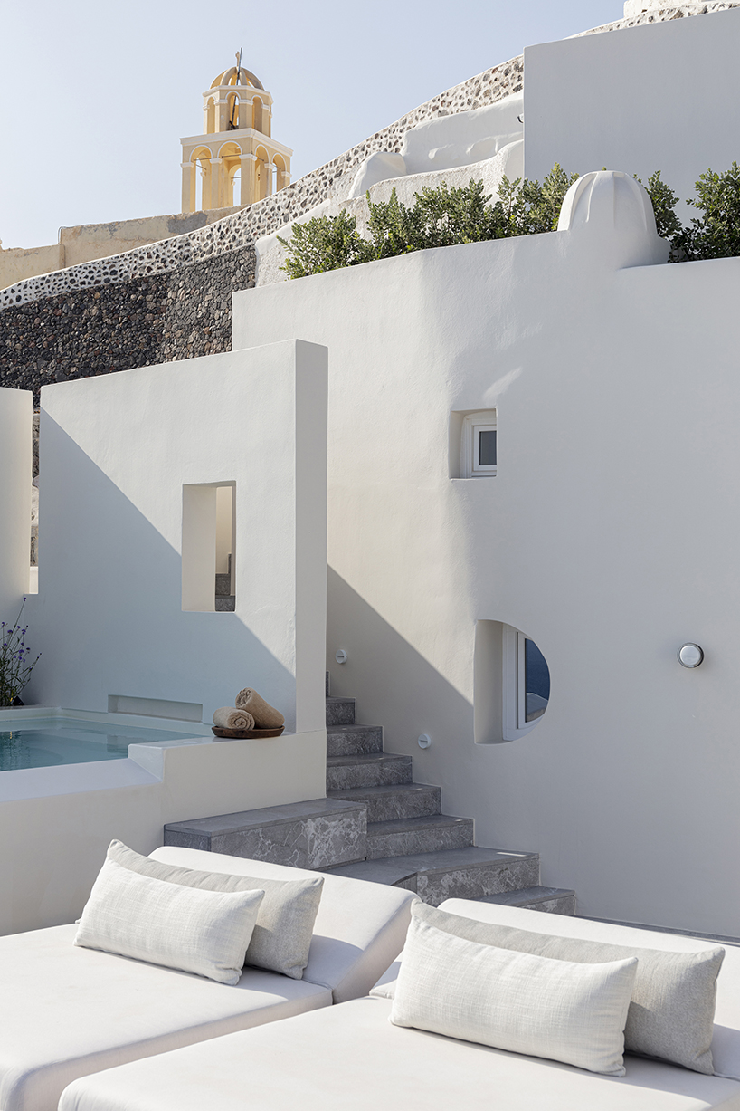 kapsimalis architects’ summer house in santorini emerges from a cliffside cave