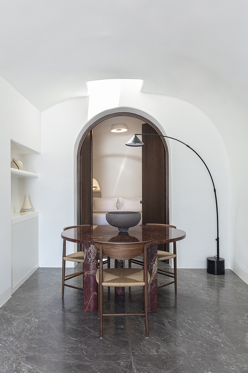 kapsimalis architects’ summer house in santorini emerges from a cliffside cave