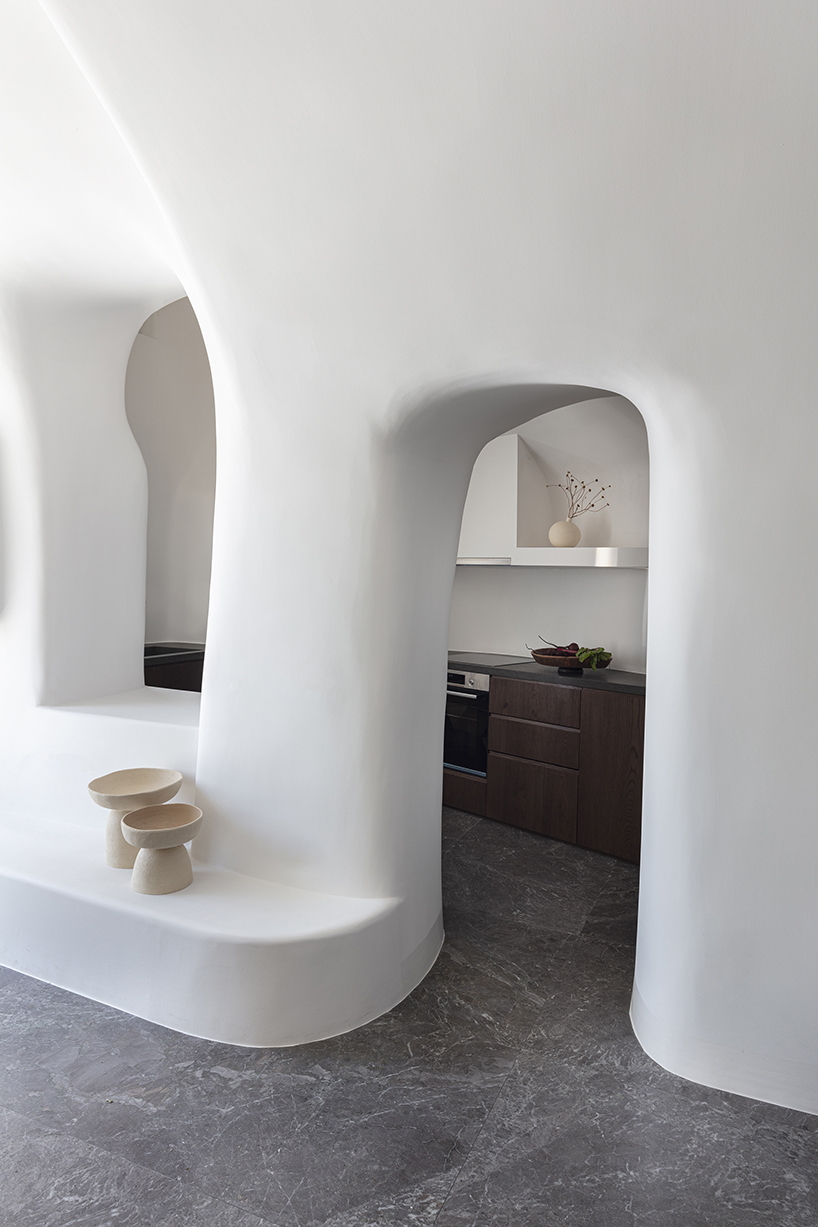 kapsimalis architects’ summer house in santorini emerges from a cliffside cave