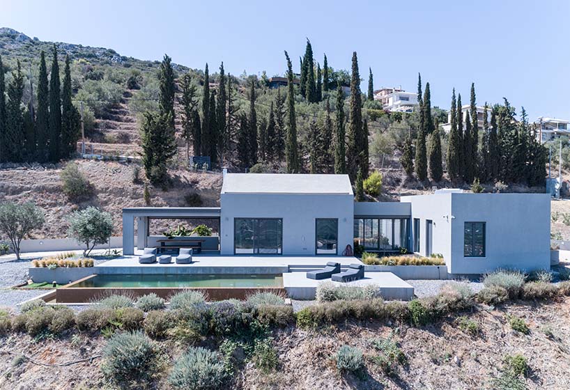 A2 architects nestles three houses into the greek coastline designboom