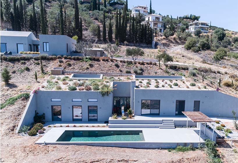 A2 architects nestles three houses into the greek coastline designboom