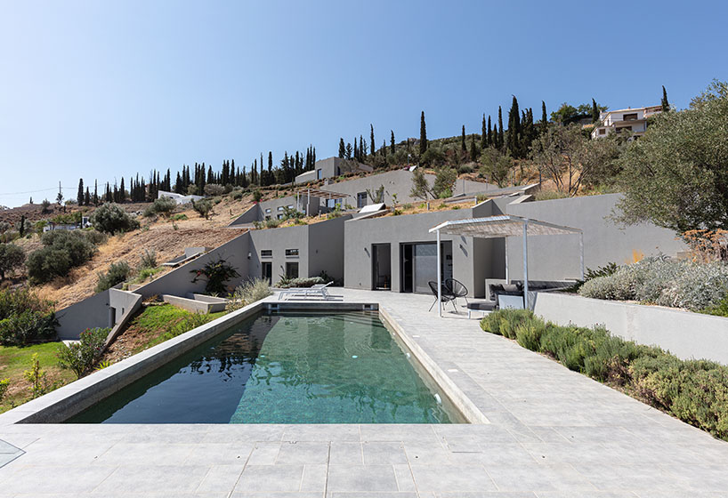 A2 architects nestles three houses into the greek coastline designboom
