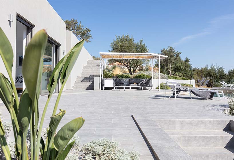 A2 architects nestles three houses into the greek coastline designboom