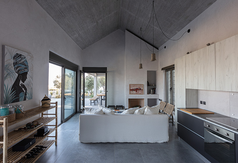 A2 architects nestles three houses into the greek coastline designboom