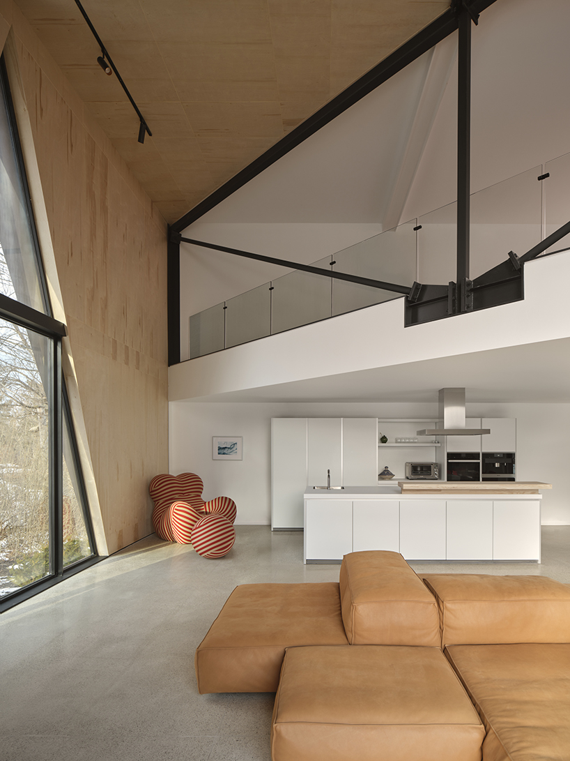 charred wood ski chalet by atelier RZLBD tucks into sloping terrain in rural canada