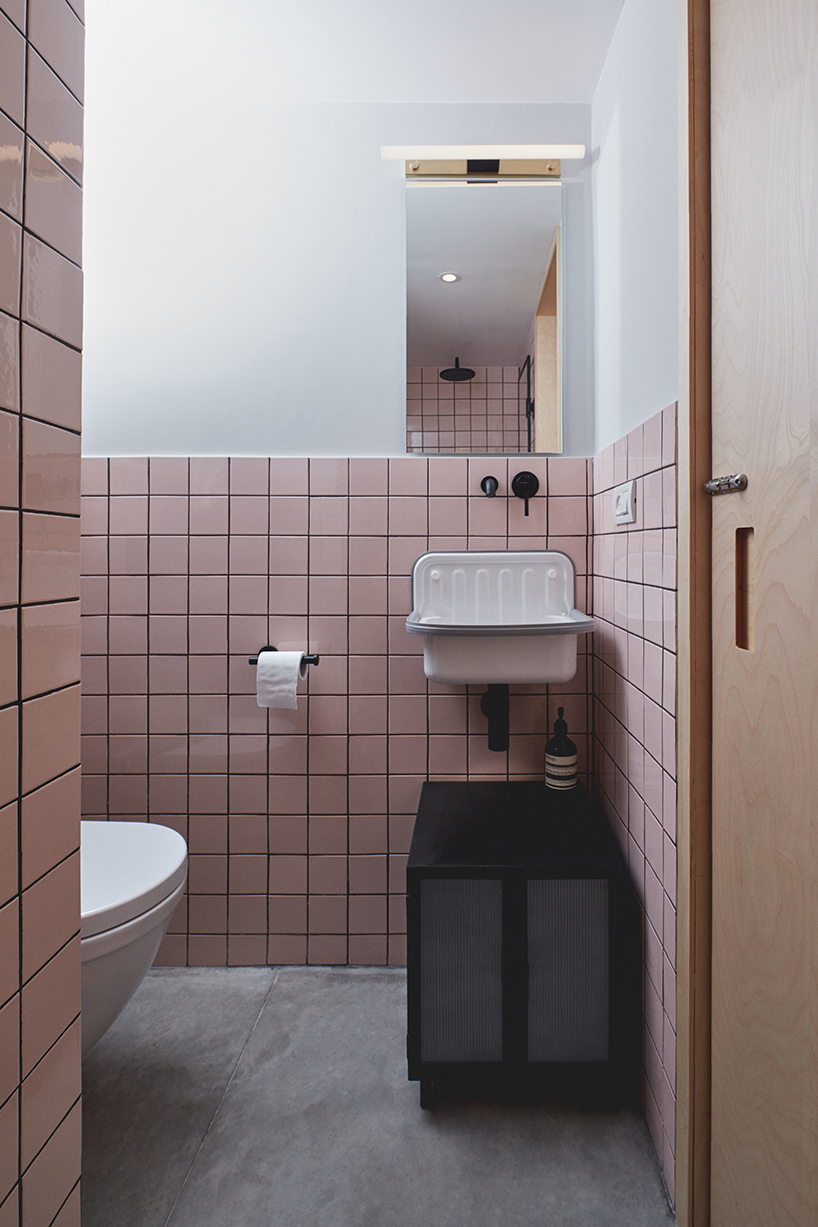 this apartment in tel aviv uses a wooden storage unit to separate private spaces - 9