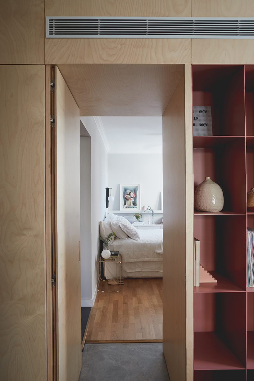 this apartment in tel aviv uses a wooden storage unit to separate private spaces - 5