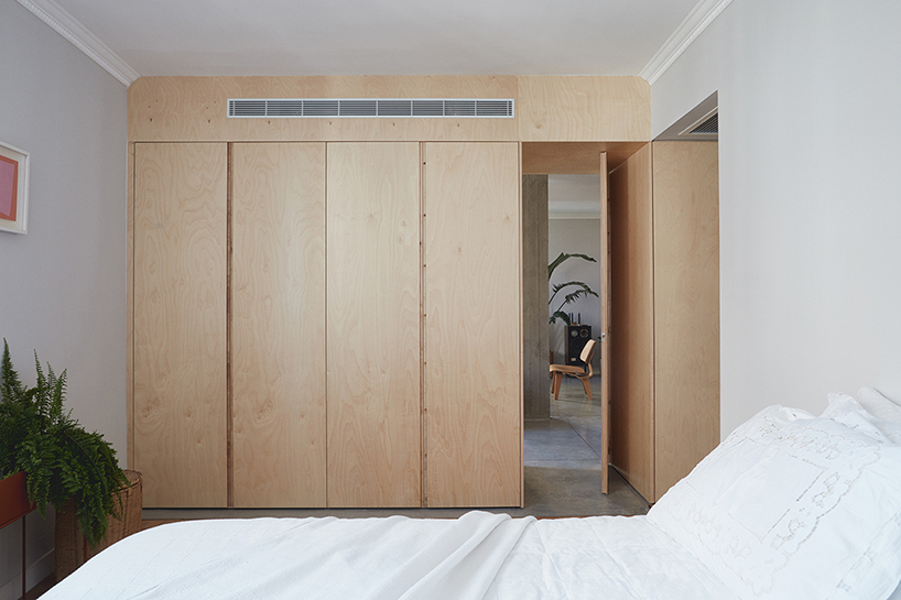 this apartment in tel aviv uses a wooden storage unit to separate private spaces - 6
