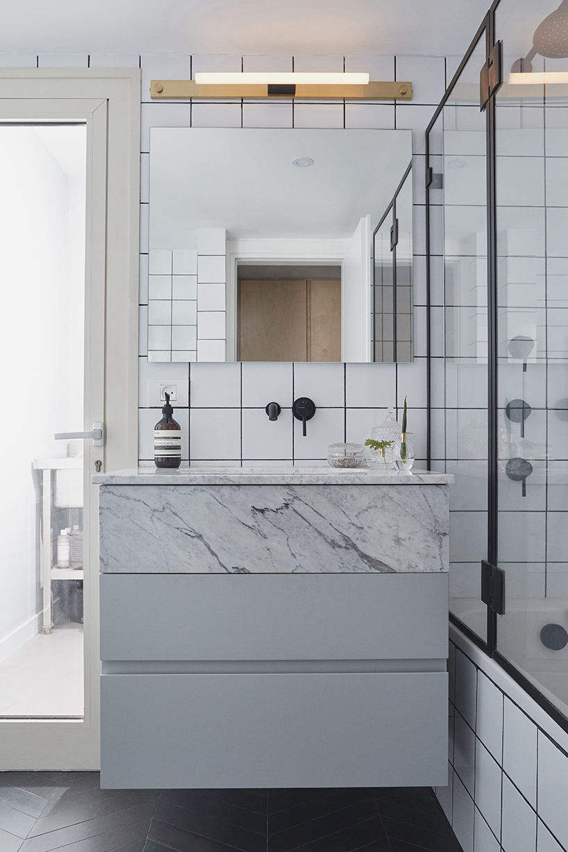 this apartment in tel aviv uses a wooden storage unit to separate private spaces - 7