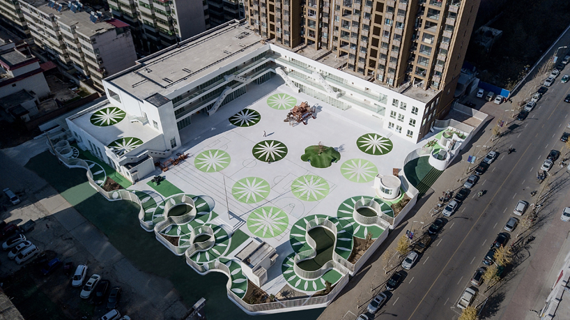 unarchitecte builds an artificial hillock into the lingbao children’s center in china designboom