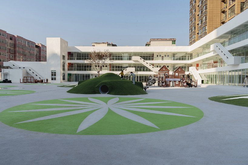 unarchitecte builds an artificial hillock into the lingbao children’s center in china designboom