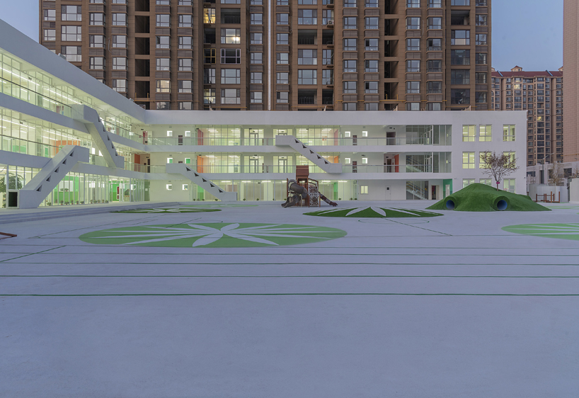 unarchitecte builds an artificial hillock into the lingbao children’s center in china designboom