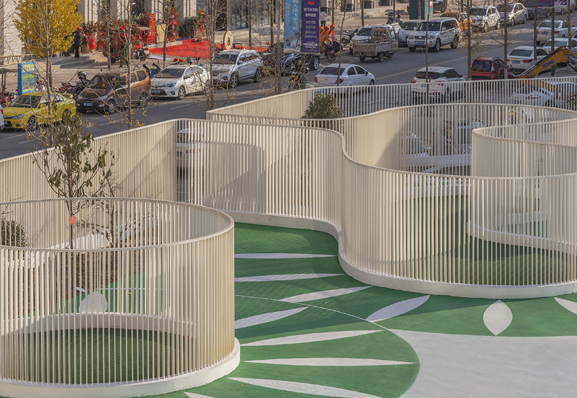 unarchitecte builds an artificial hillock into the lingbao children’s center in china designboom