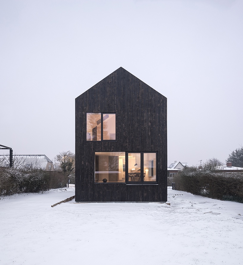 burnt timber composes barn-shaped villa by nord architects in copenhagen