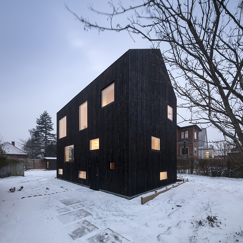 burnt timber composes barn-shaped villa by nord architects in copenhagen