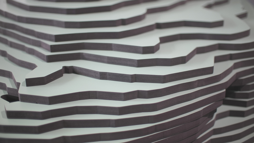 ENORME studio layers colored wood to represent 'astral bodies' that have landed on earth designboom