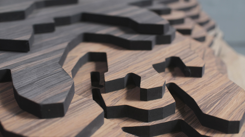 ENORME studio layers colored wood to represent 'astral bodies' that have landed on earth designboom