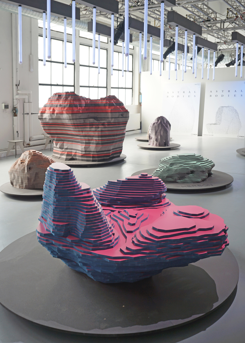 ENORME studio layers colored wood to represent 'astral bodies' that have landed on earth designboom