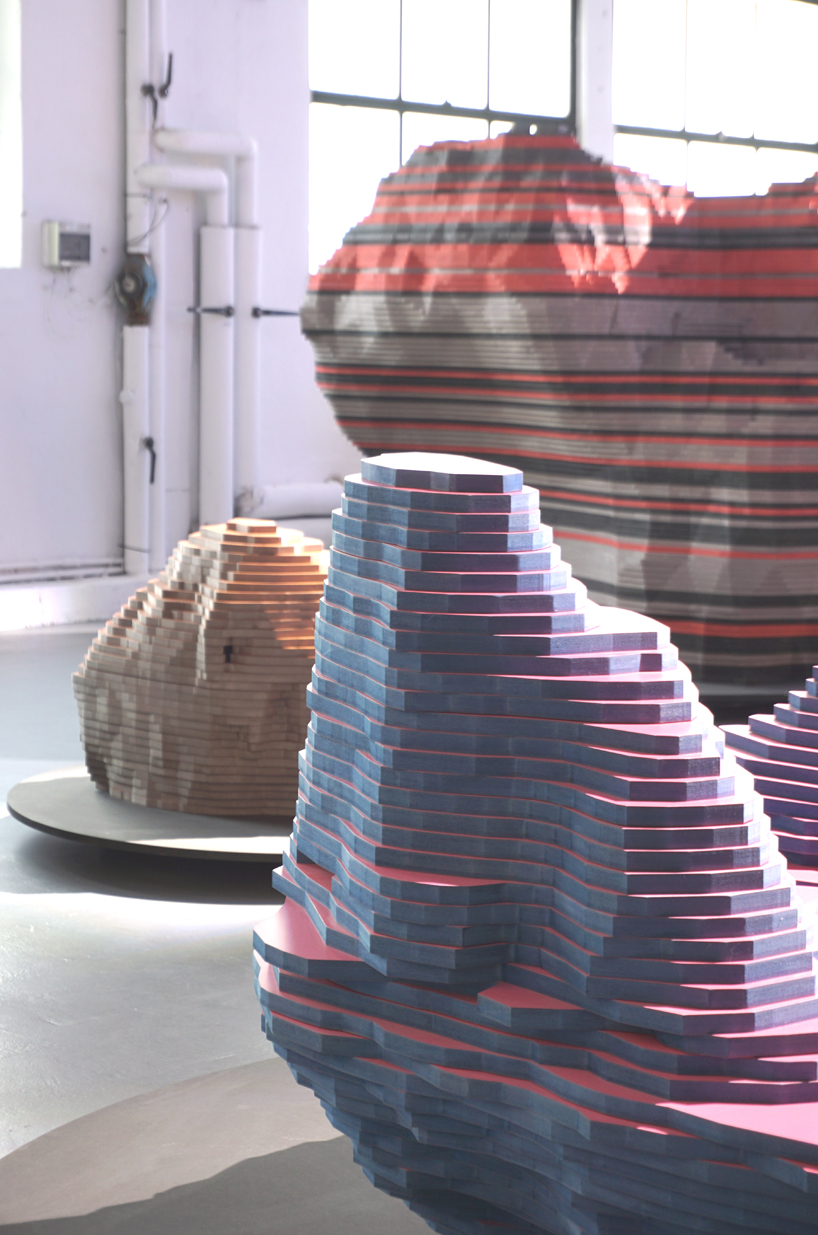 ENORME studio layers colored wood to represent 'astral bodies' that have landed on earth designboom
