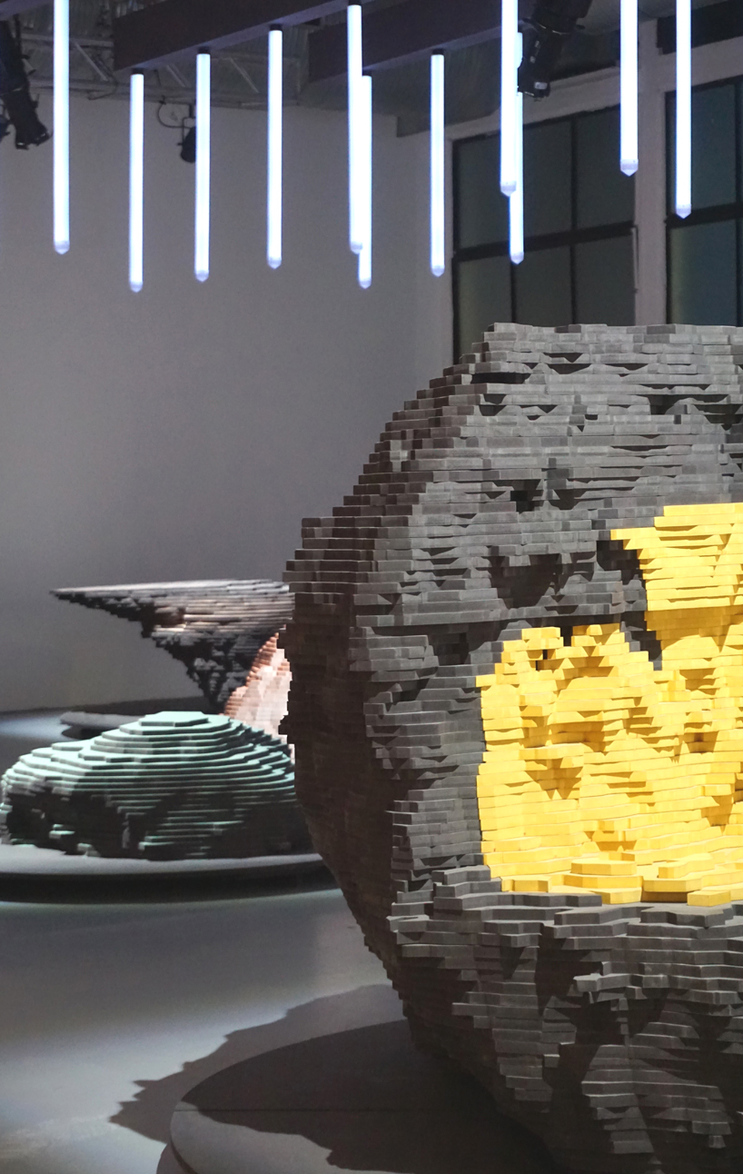 ENORME studio layers colored wood to represent 'astral bodies' that have landed on earth designboom