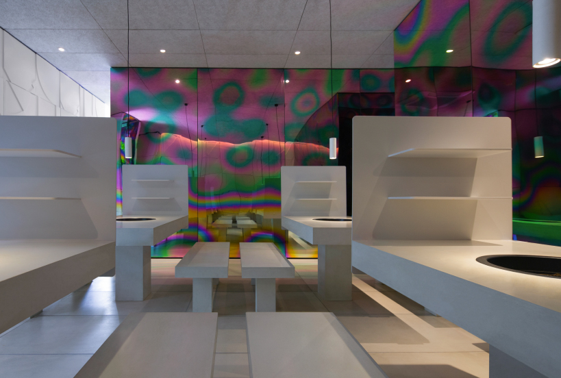 iridescent diner by infinity nide features colored, electroplated steel and white concrete