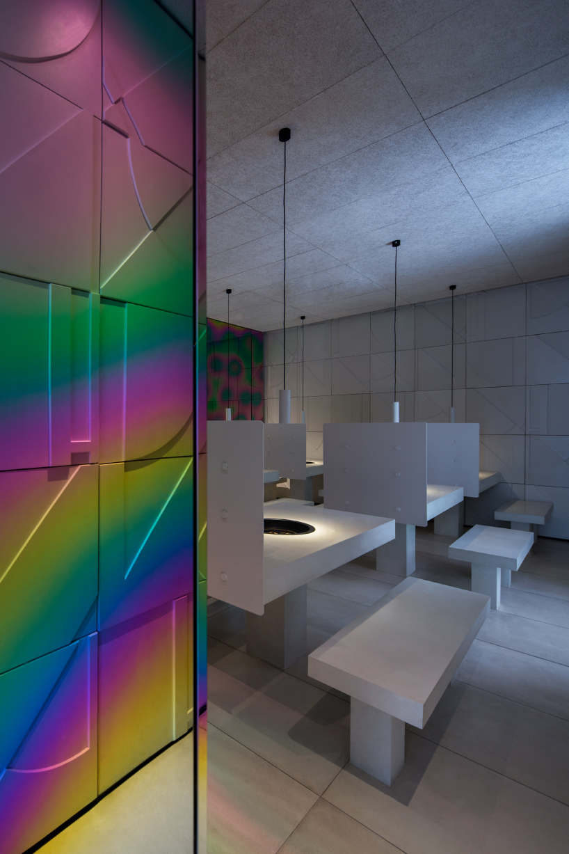 iridescent diner by infinity nide features colored, electroplated steel and white concrete