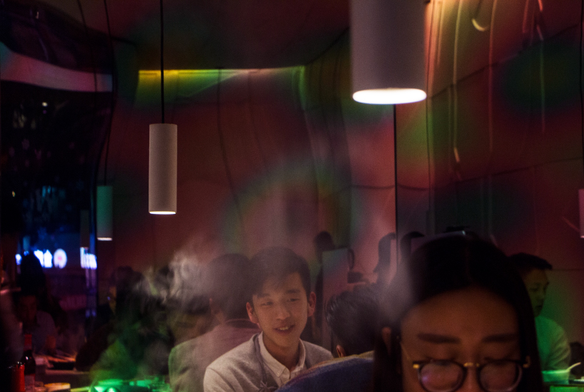 iridescent diner by infinity nide features colored, electroplated steel and white concrete