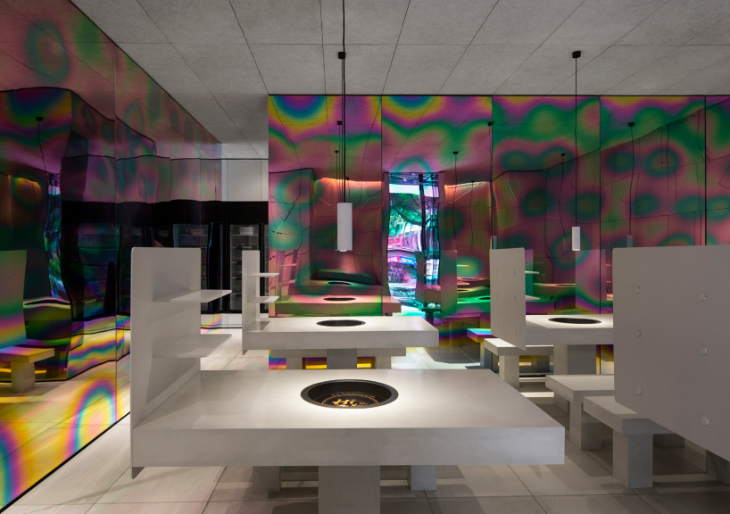 iridescent diner by infinity nide features colored, electroplated steel and white concrete