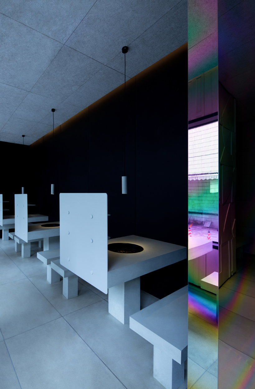 iridescent diner by infinity nide features colored, electroplated steel and white concrete