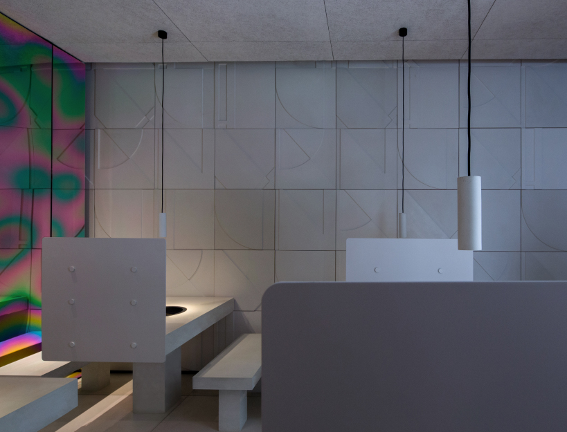 iridescent diner by infinity nide features colored, electroplated steel and white concrete