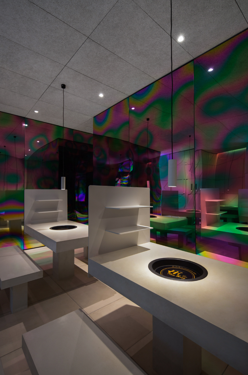 iridescent diner by infinity nide features colored, electroplated steel and white concrete