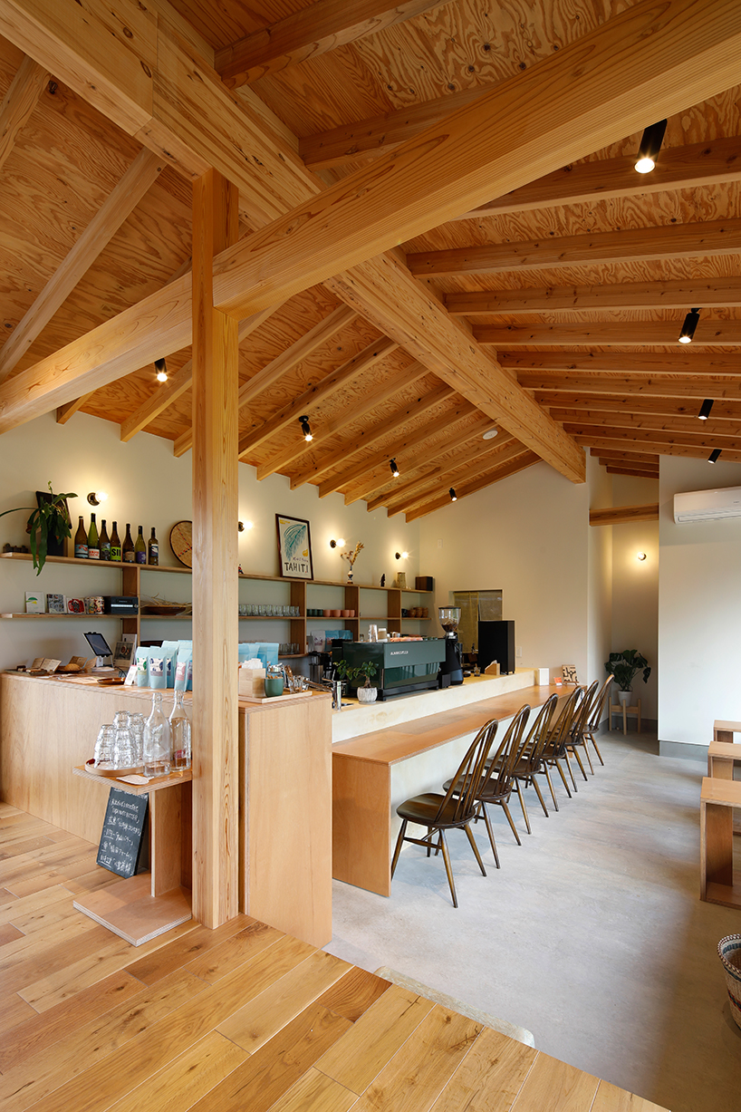 wooden coffee shop in japan sets up multileveled interiors under an eave roof - 2