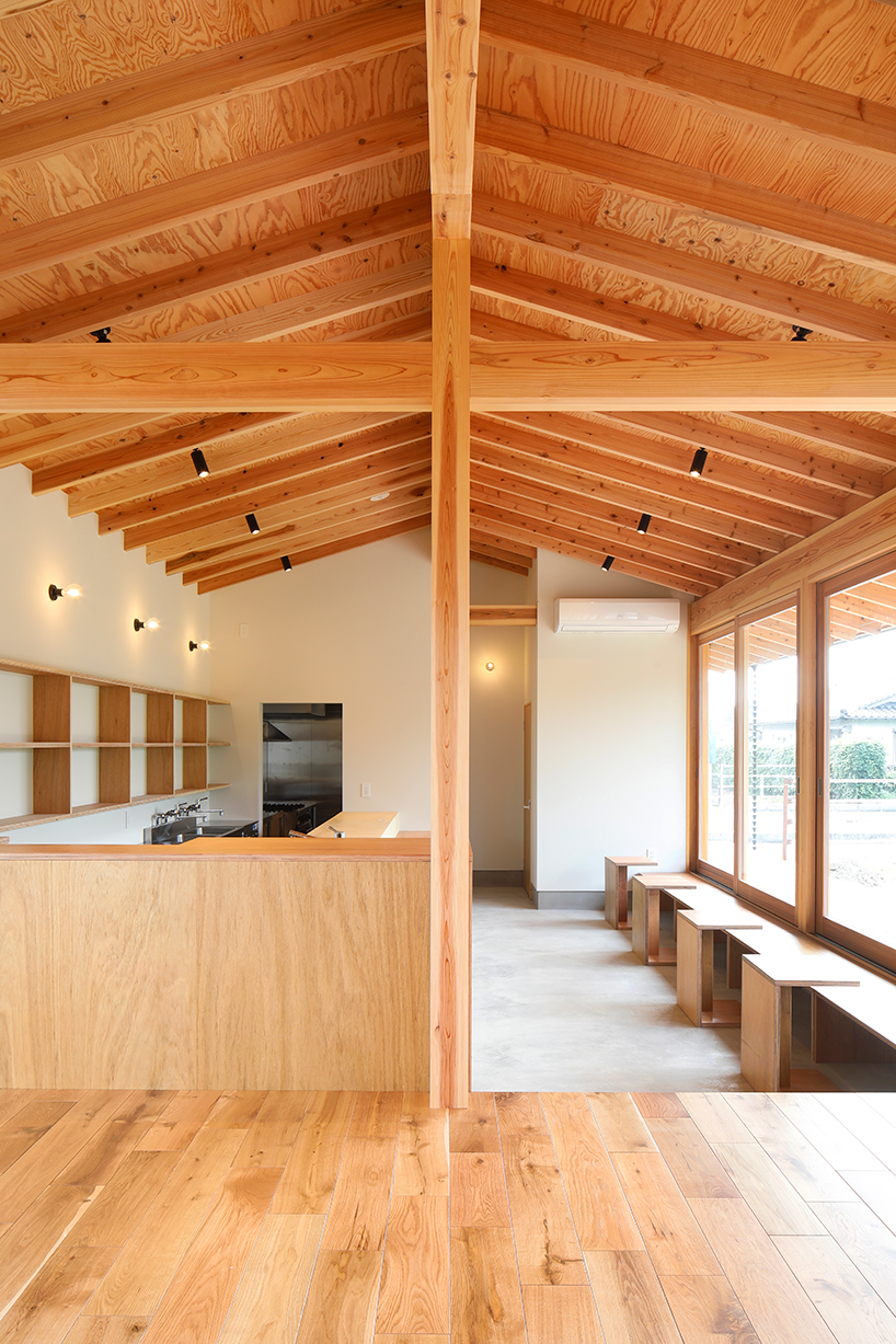 wooden coffee shop in japan sets up multileveled interiors under an eave roof - 3