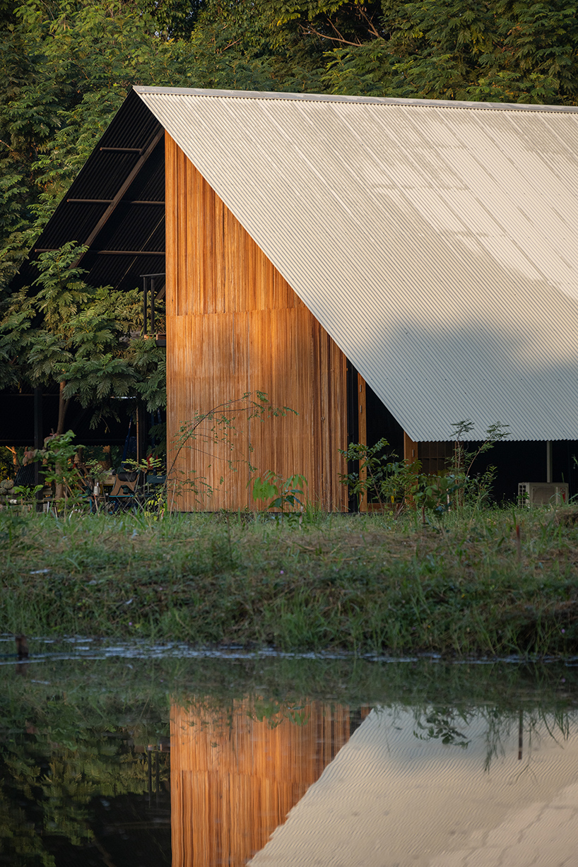 old wooden frames and a steel gable roof construct sher maker's studio in thailand
