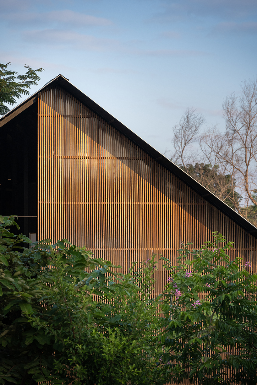 old wooden frames and a steel gable roof construct sher maker's studio in thailand