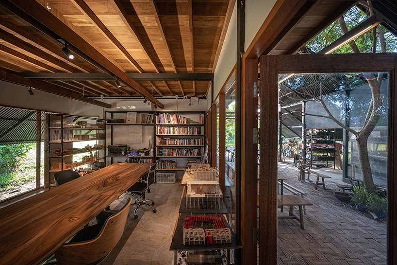 old wooden frames and a steel gable roof construct sher maker's studio in thailand