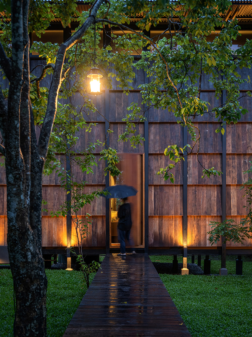  wooden off-grid cabin by sher maker connects travelers to the serene mountainous landscape of thailand