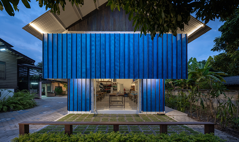 sher maker tops pleated wood longhouse with steel roof for fashion studio in chiang mai