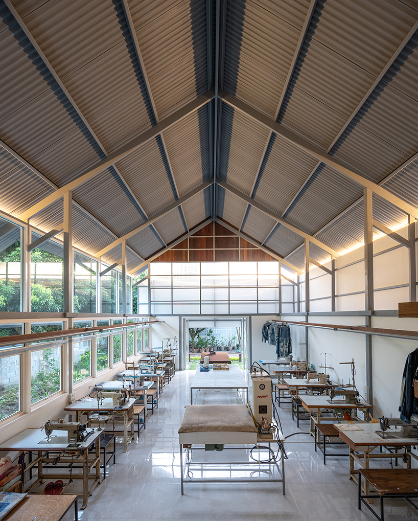 sher maker tops pleated wood longhouse with steel roof for fashion studio in chiang mai