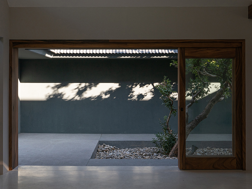 gabled longhouse showroom by sher maker celebrates artisanal woodworking in chiang mai