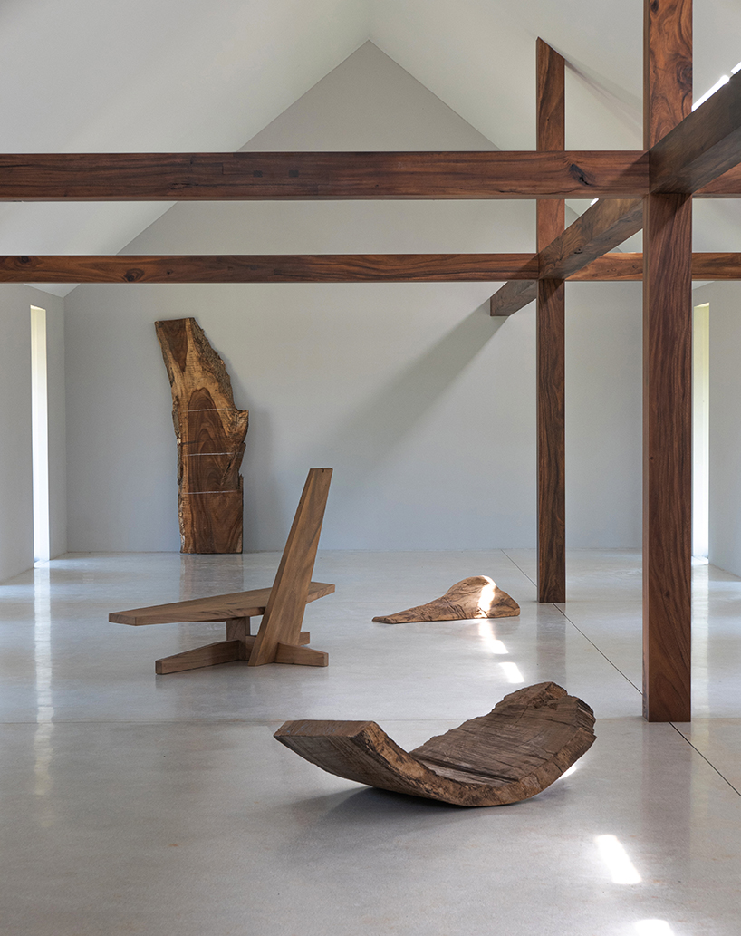 gabled longhouse showroom by sher maker celebrates artisanal woodworking in chiang mai